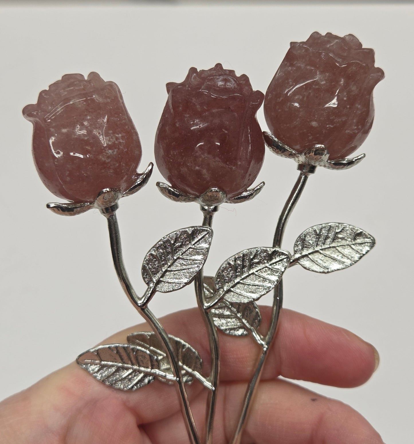 Strawberry Quartz crystal roses mounted on silver stems.