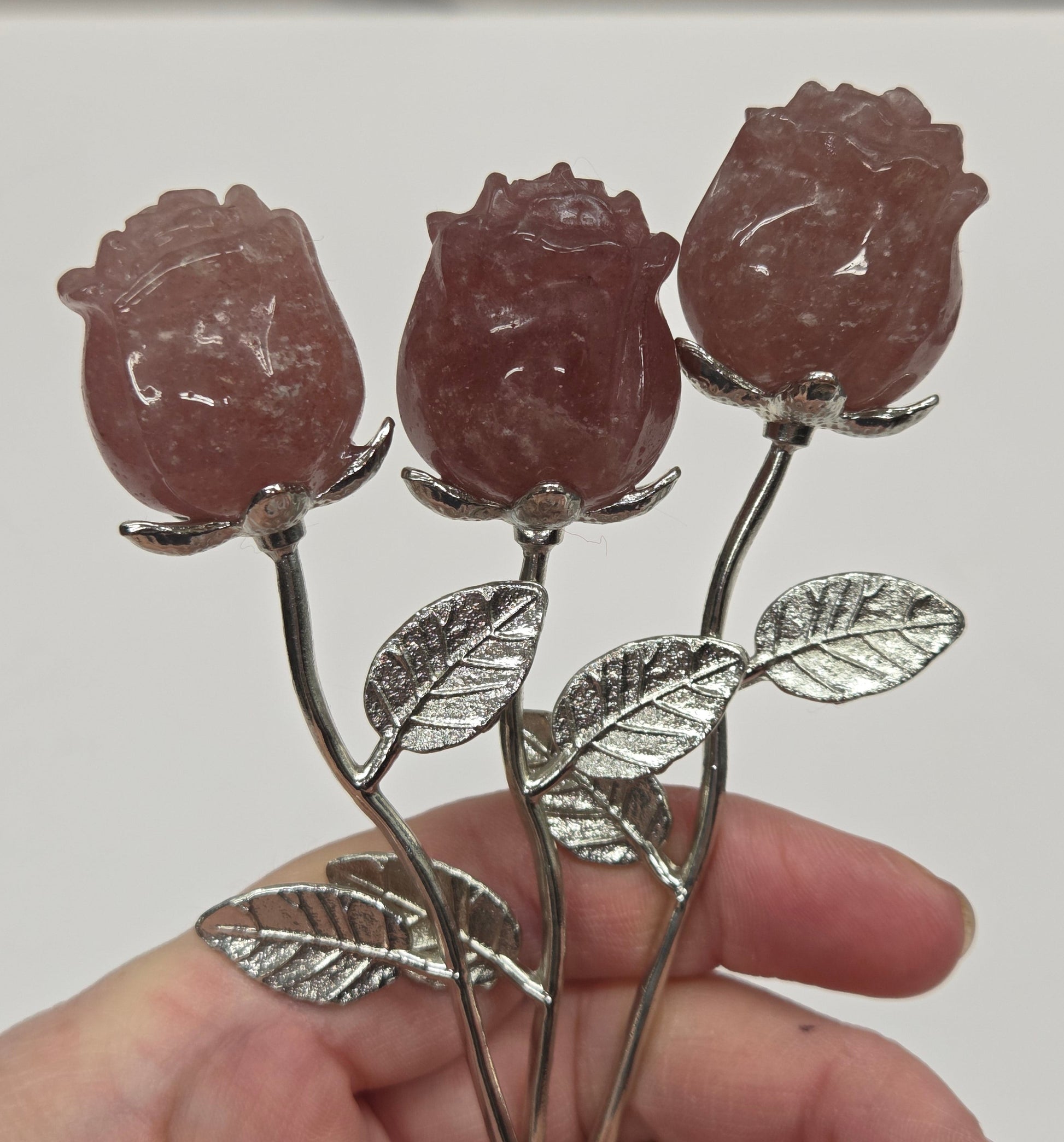 Strawberry Quartz crystal roses mounted on silver stems.