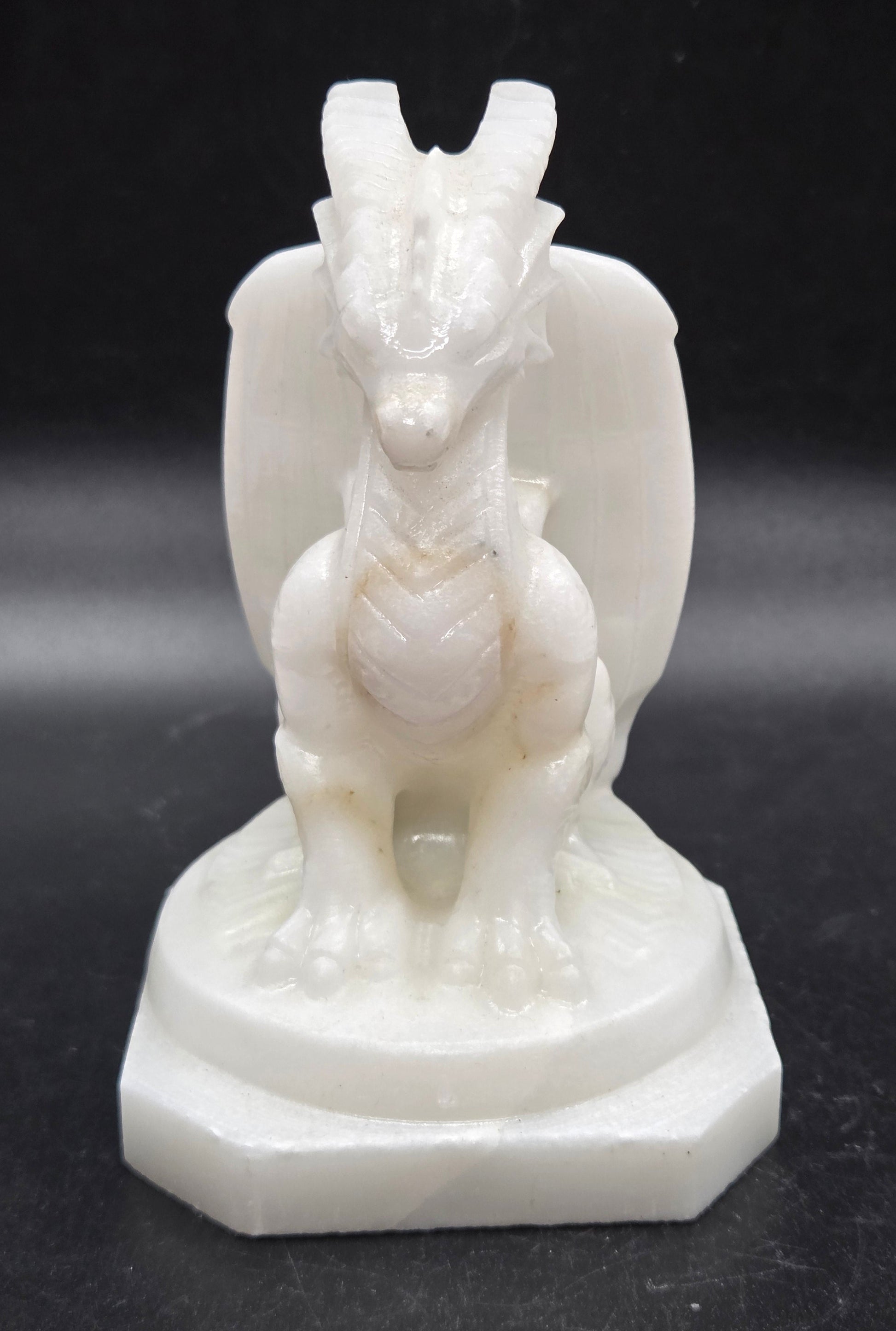 White Jade crystal dragon sculpture on a dark background