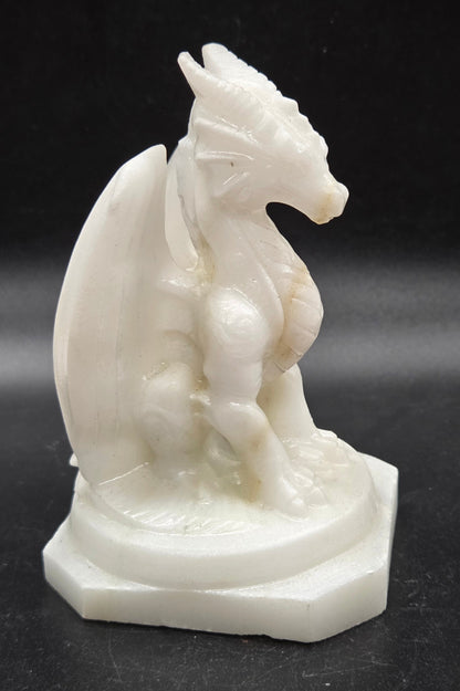 White Jade crystal dragon sculpture on a dark background