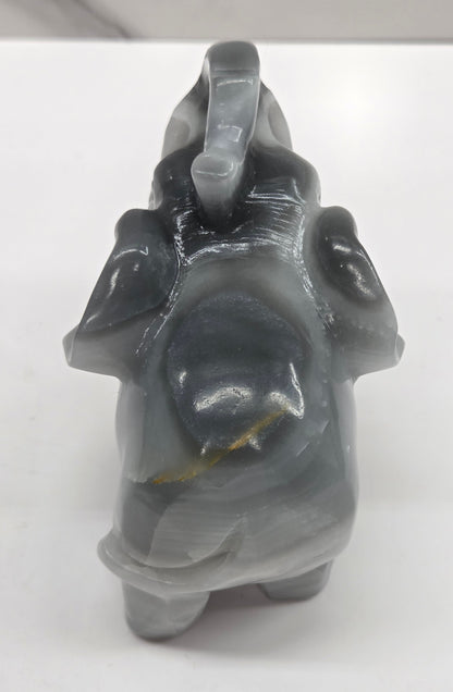 Gray Agate elephant carving on a white surface with a neutral background