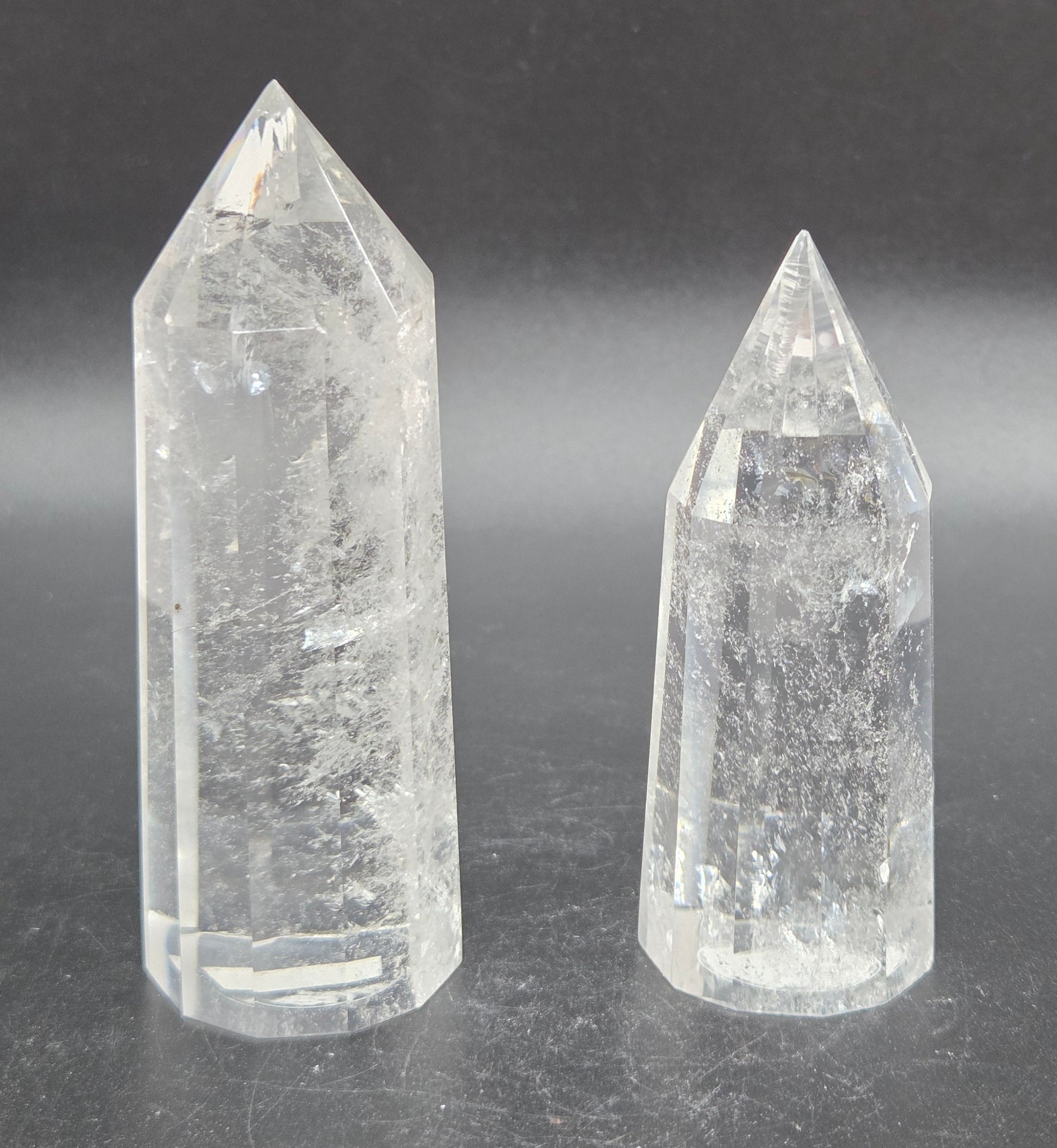 Two clear crystal points on a dark background