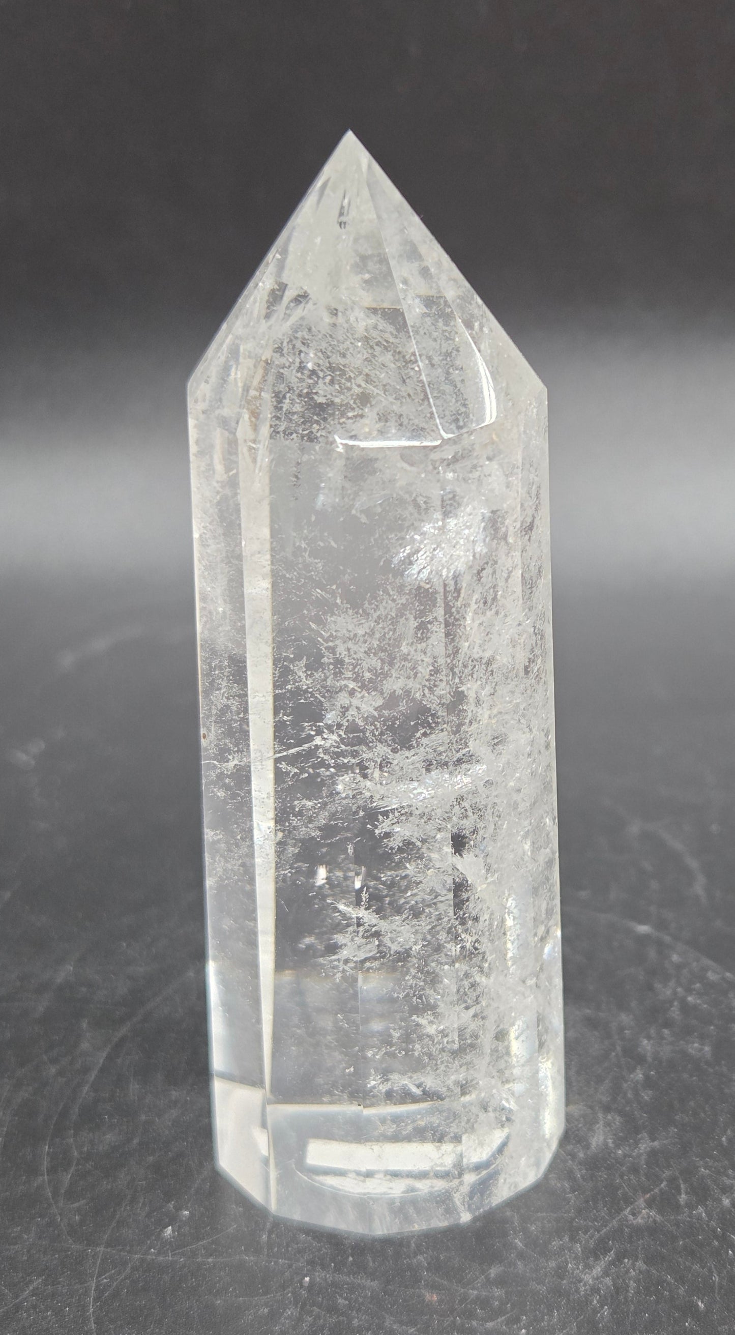 Clear crystal point on a dark surface