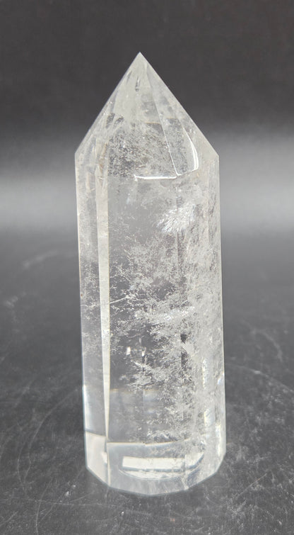 Clear crystal point on a dark surface