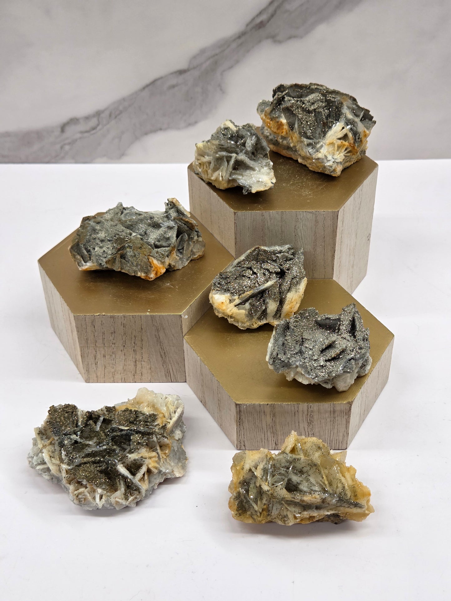 Mineral sample set on a wooden stand with a white background