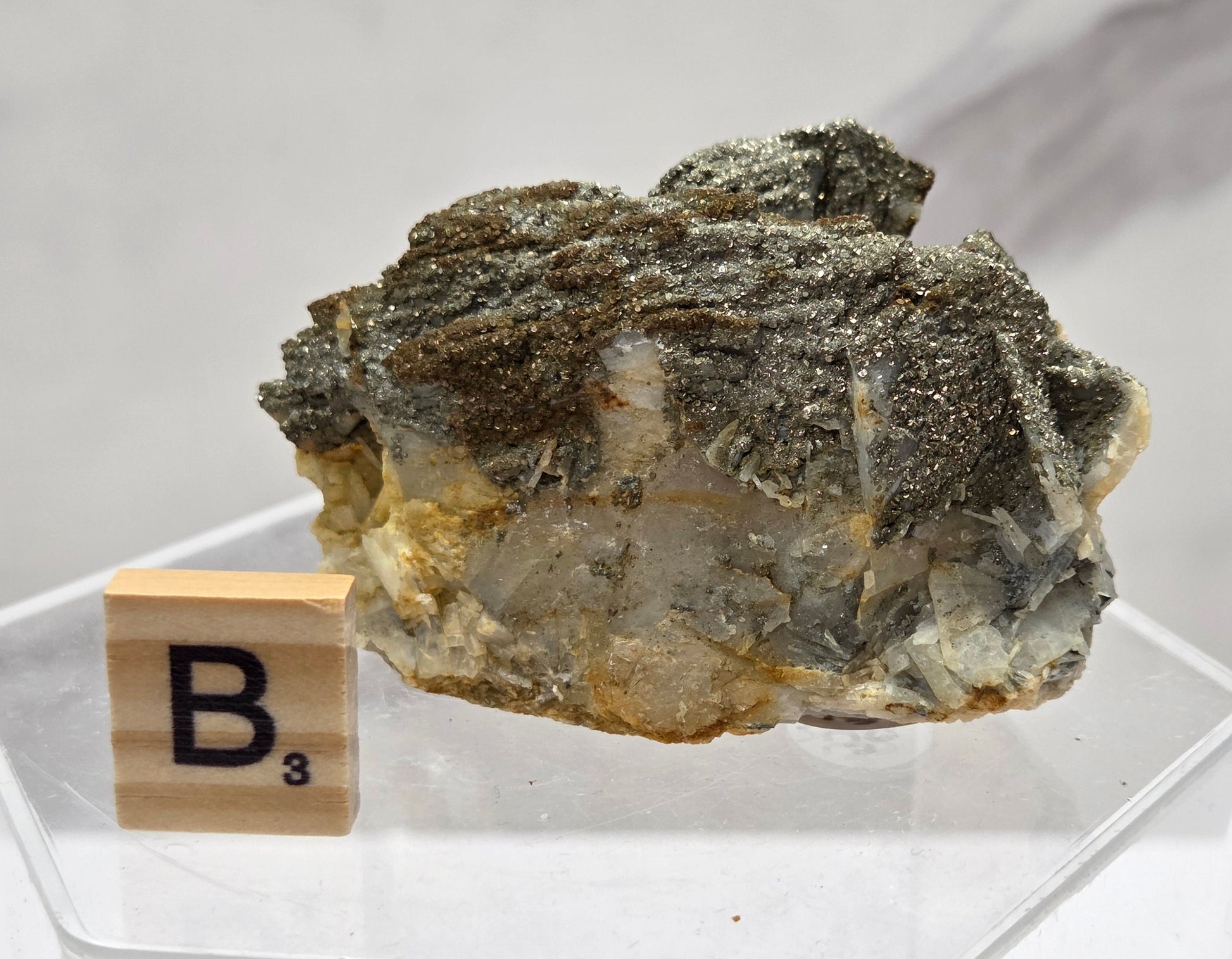 Mineral sample with a wooden label on a white background