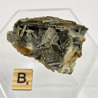 Mineral sample on a white background with a wooden label