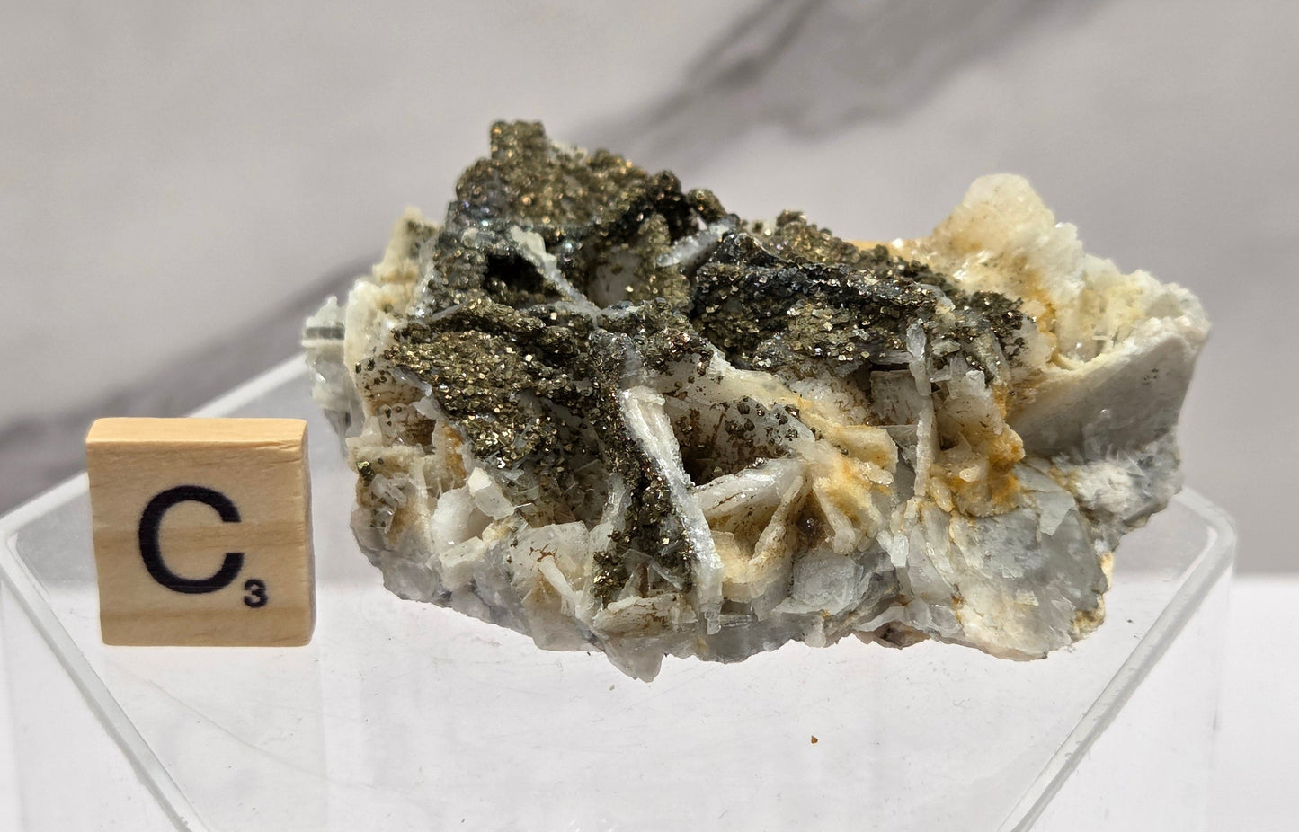 Mineral sample on a stand with a label in the background