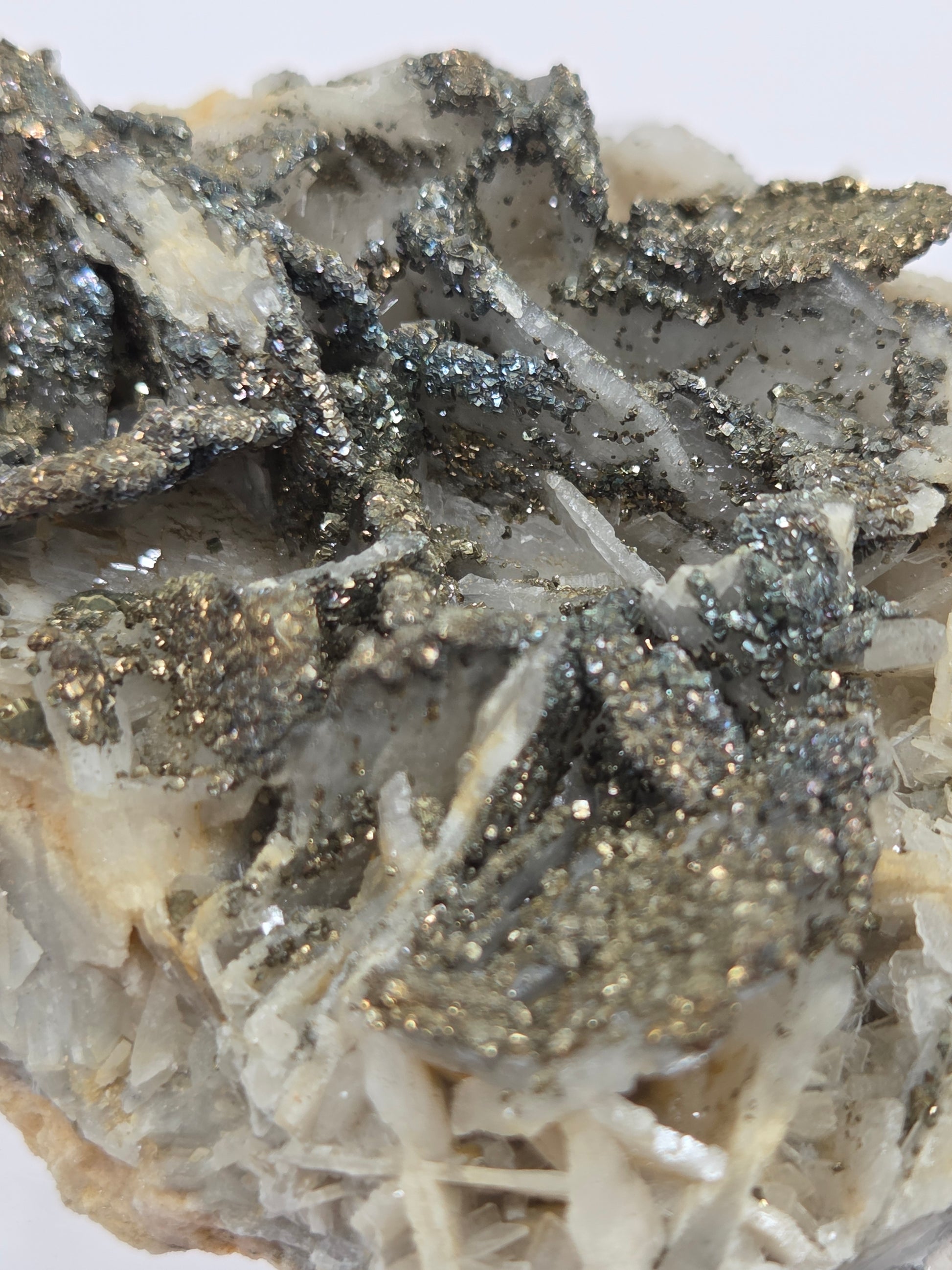 Close-up of a crystal formation with pyrite on a white background
