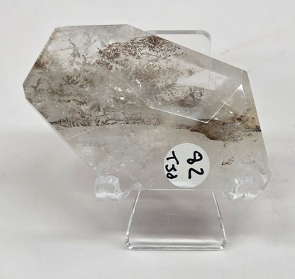 Dendritic Quartz free form on an acrylic stand against a white background