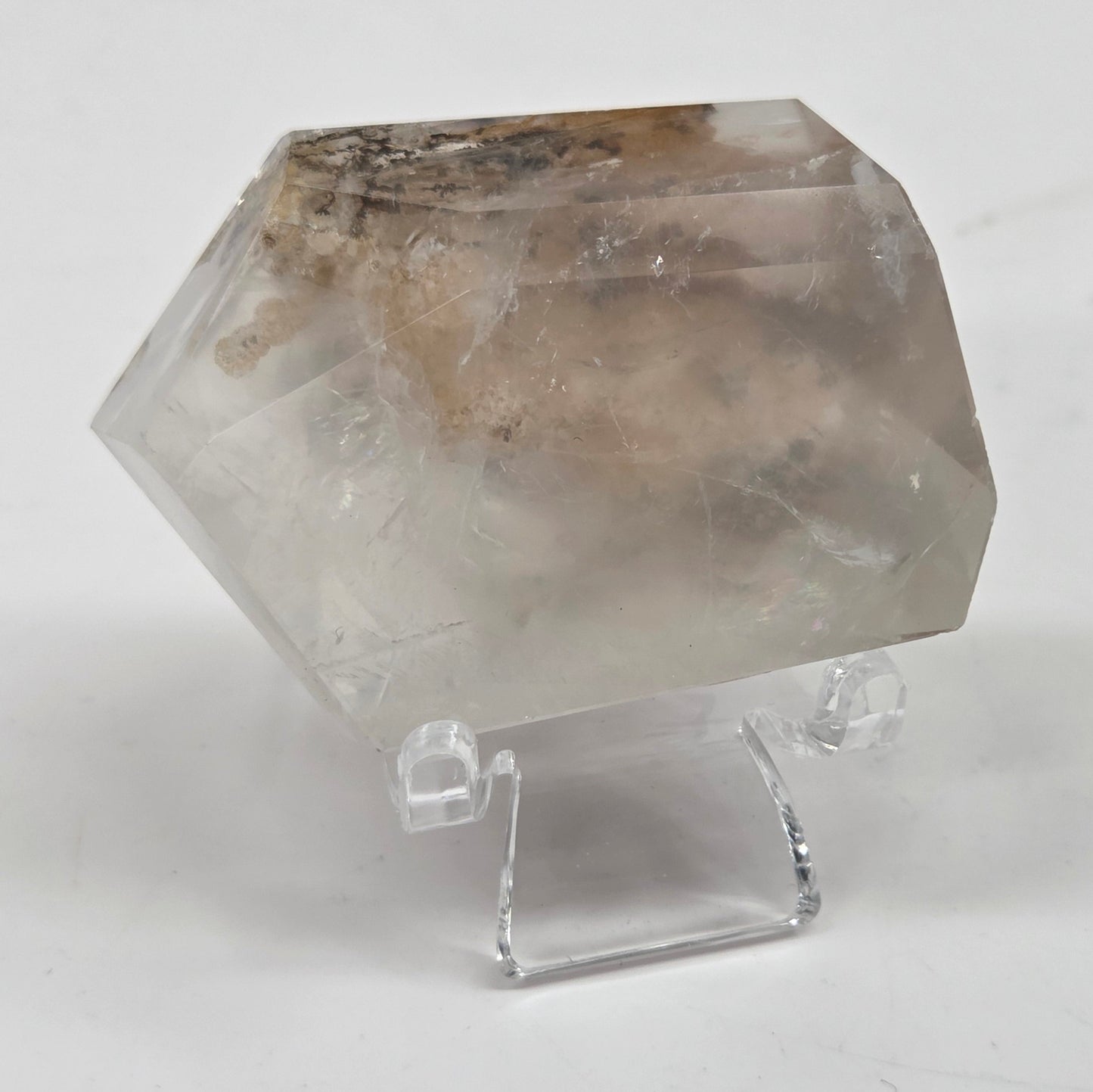 Dendritic Quartz free form on an acrylic stand against a white background
