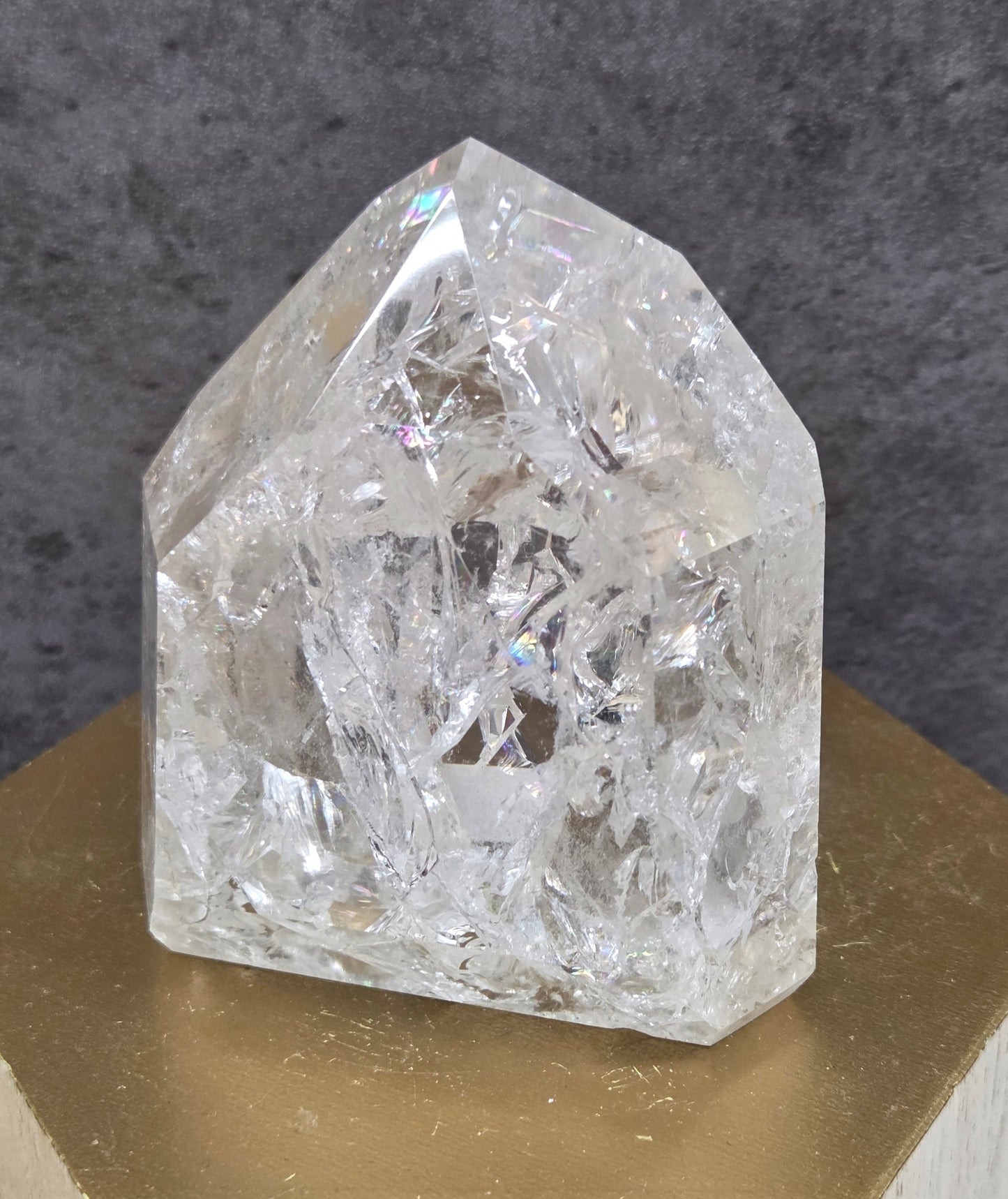 Clear Quartz crystal tower displayed against a neutral background.