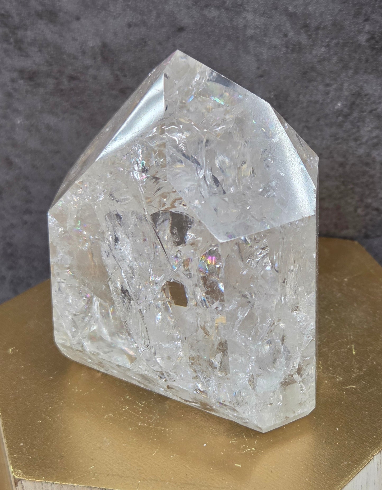 Clear Quartz crystal tower displayed against a neutral background.