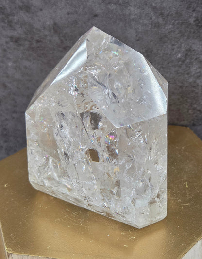 Clear Quartz crystal tower displayed against a neutral background.