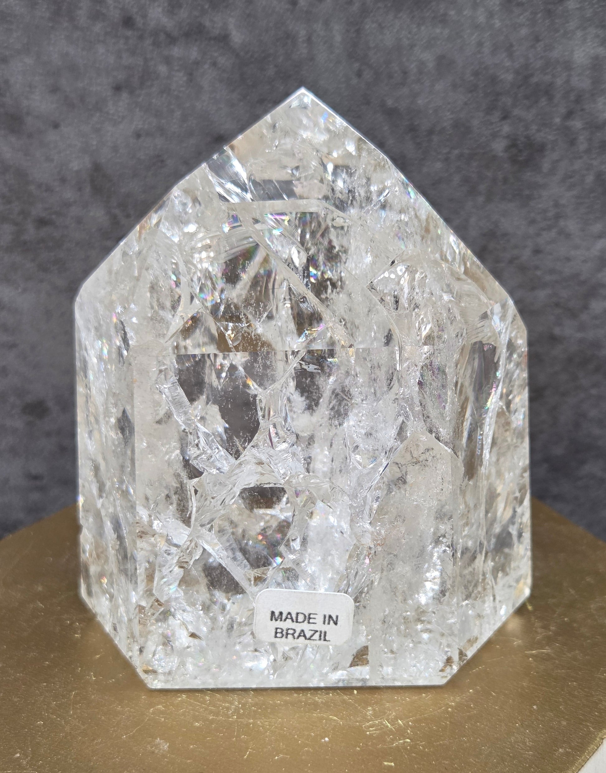 Clear Quartz crystal tower displayed against a neutral background.