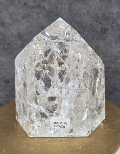 Clear Quartz crystal tower displayed against a neutral background.