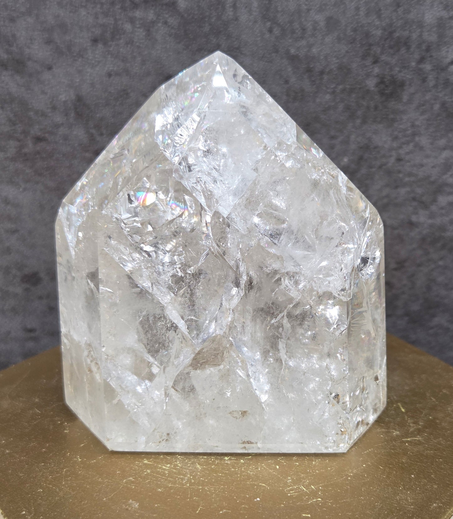 Clear Quartz crystal tower displayed against a neutral background.