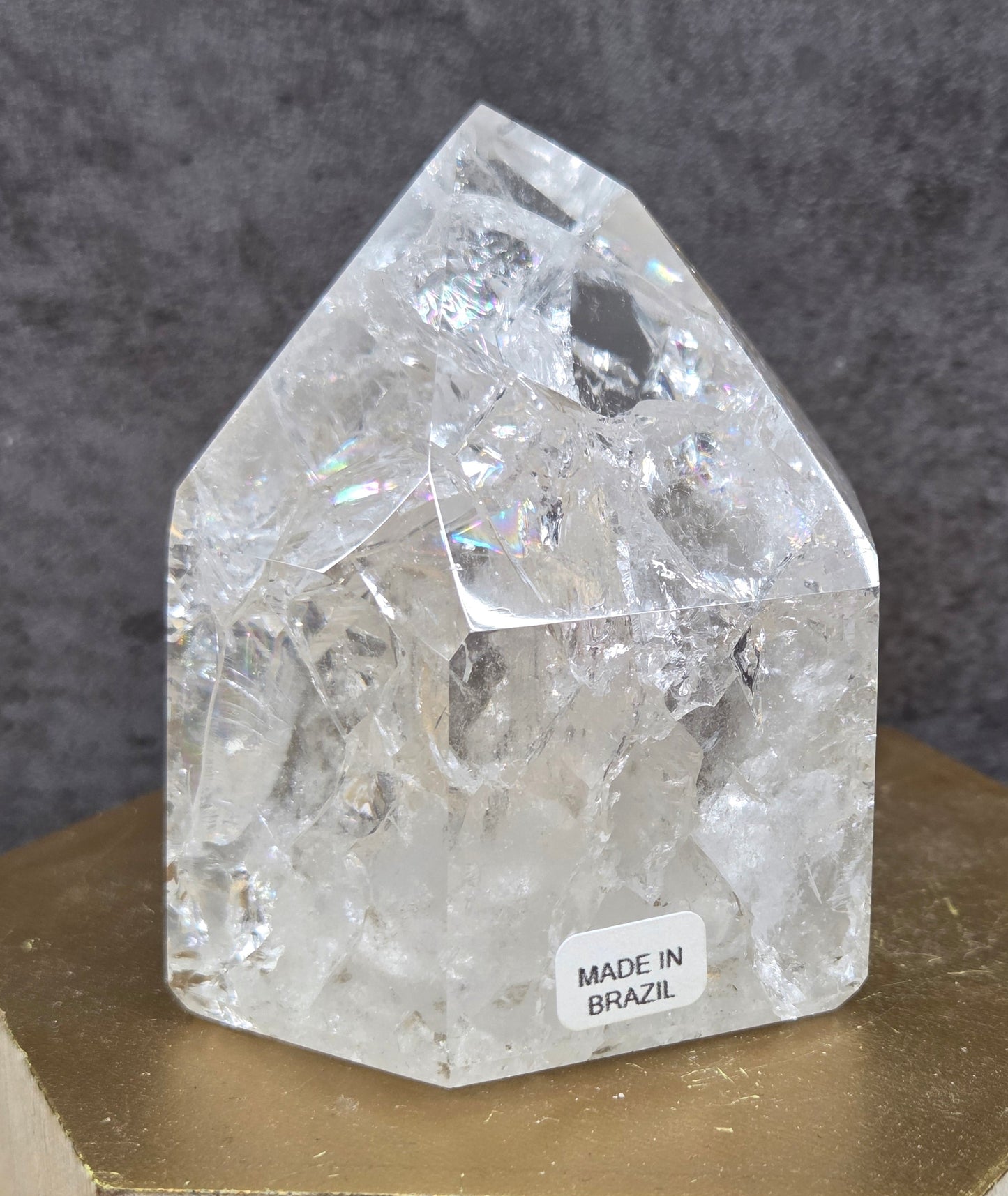 Clear Quartz crystal tower displayed against a neutral background.