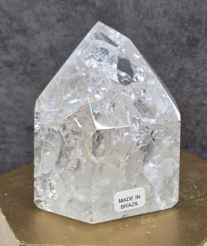 Clear Quartz crystal tower displayed against a neutral background.