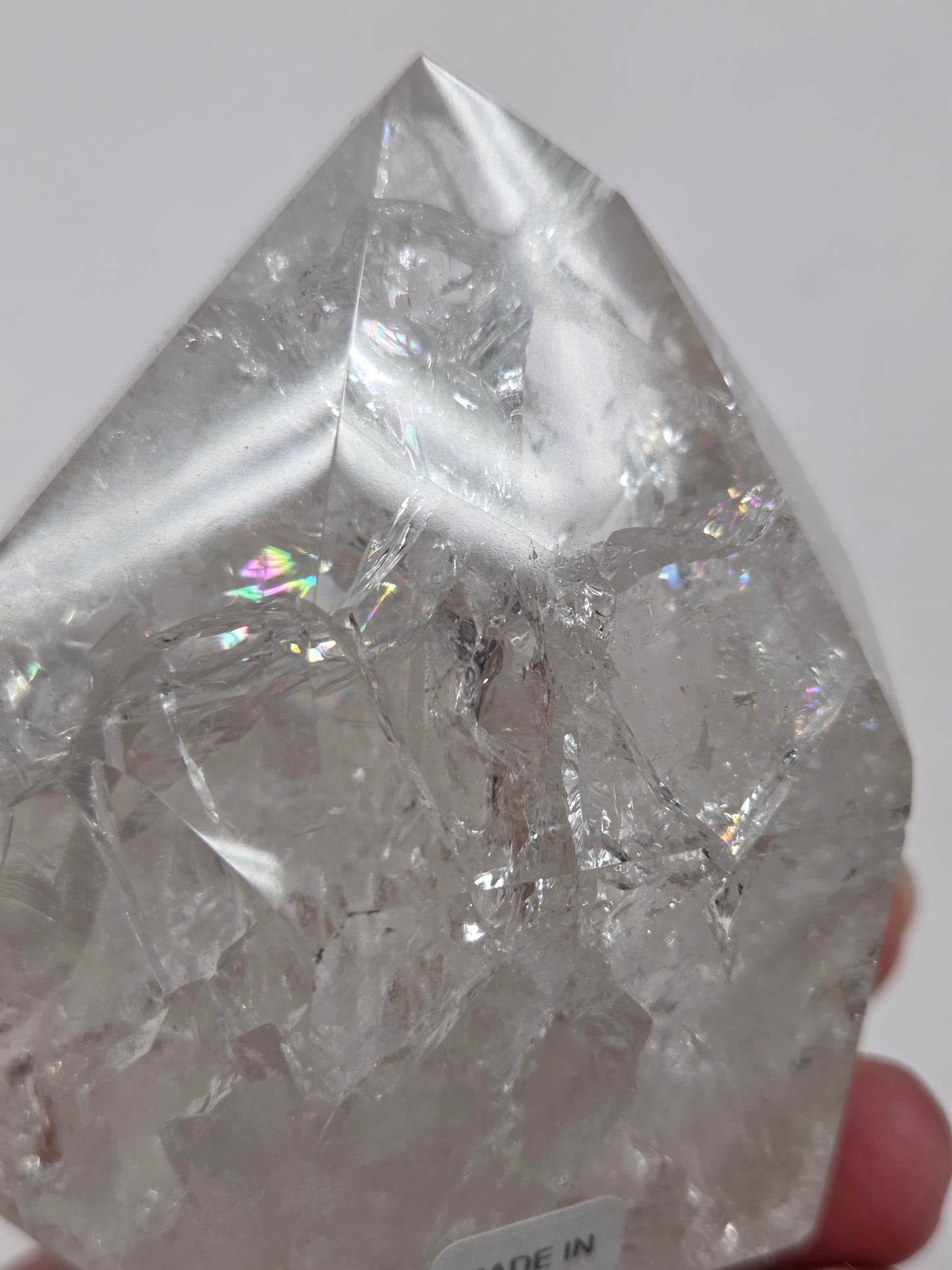 Clear Quartz crystal tower displayed against a neutral background.