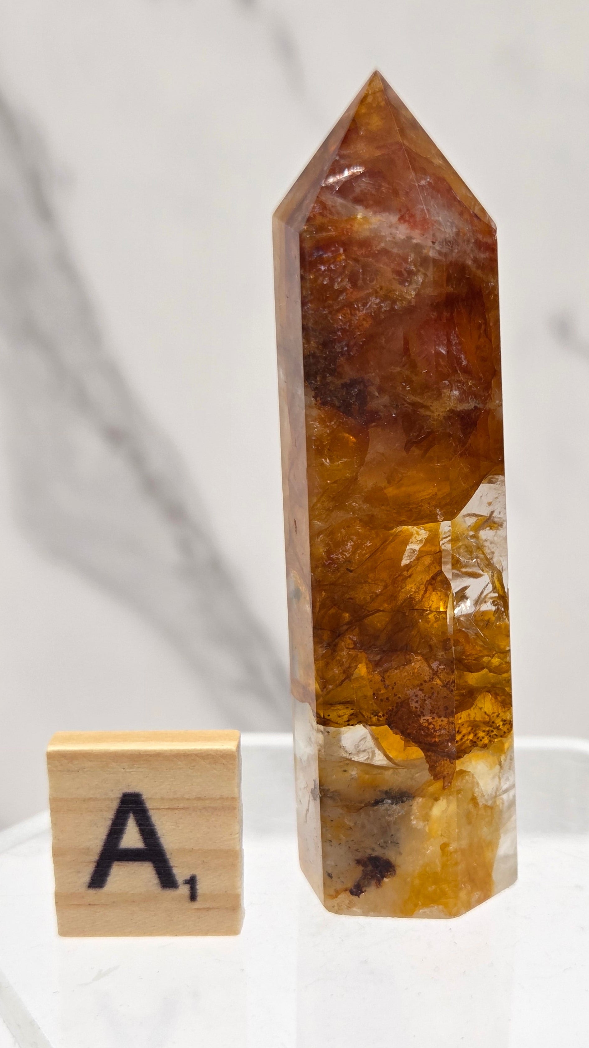 Golden Healer tower on a clear stand against a white background
