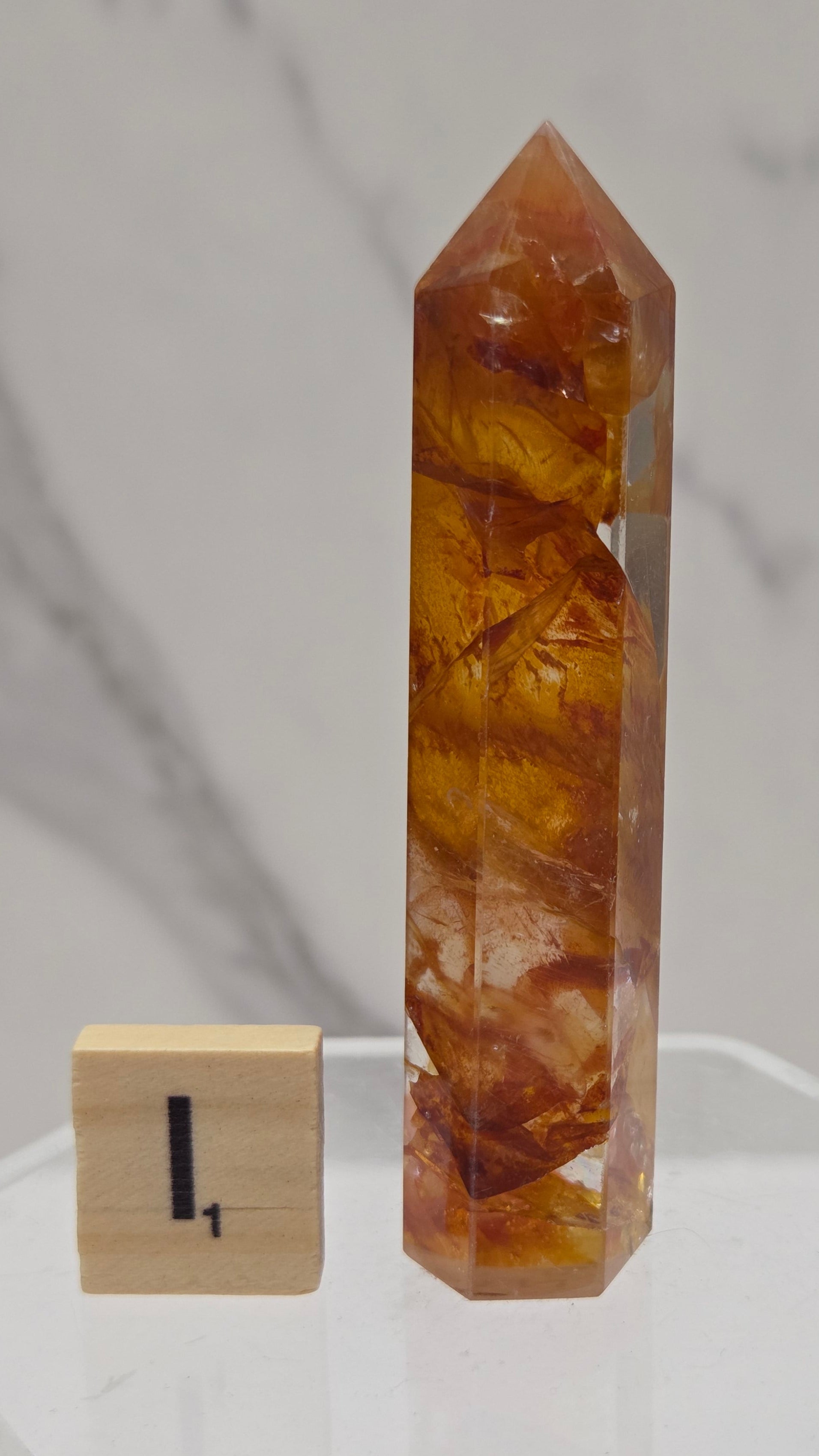 Golden Healer tower on a clear stand against a white background