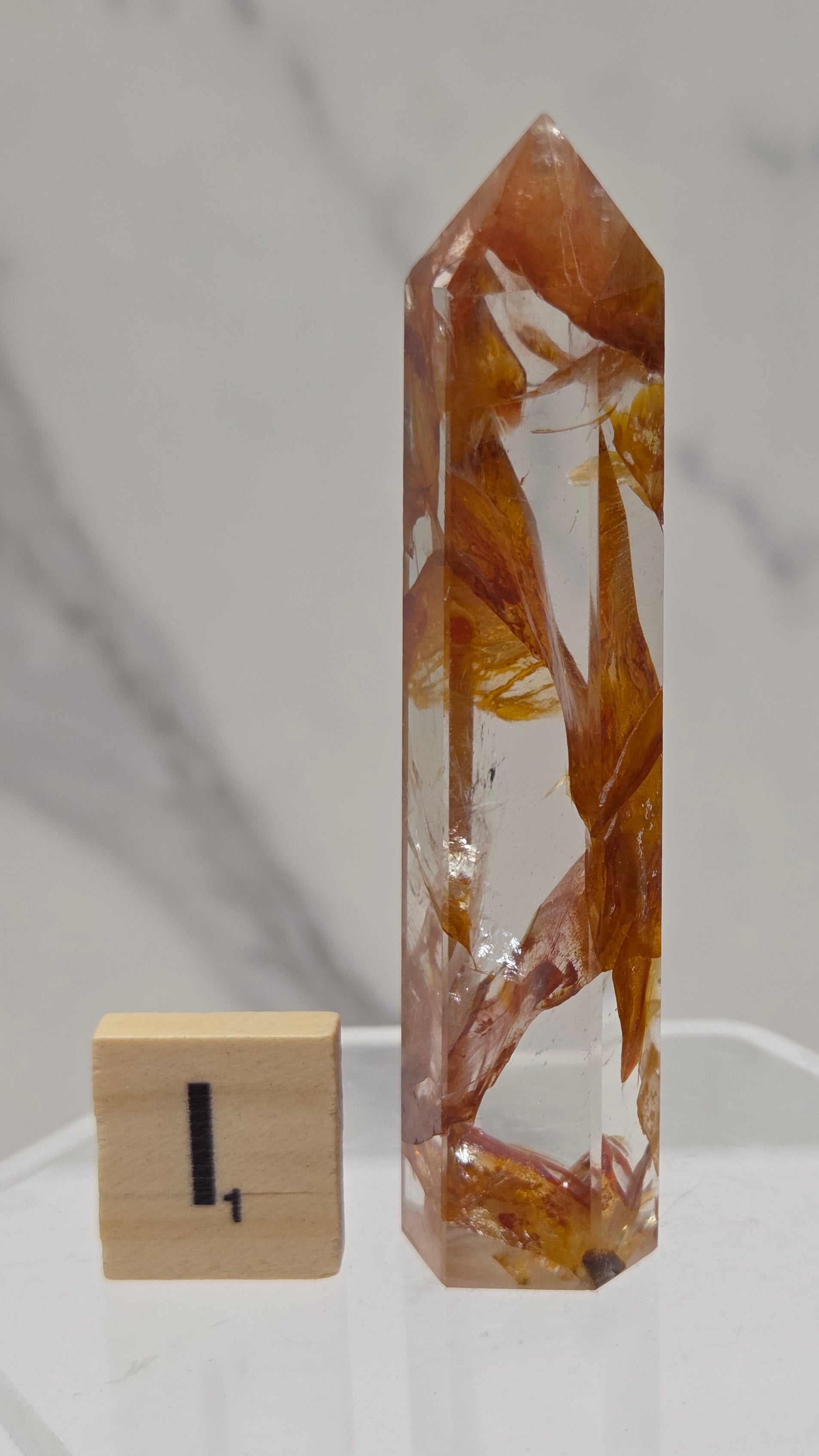 Golden Healer tower on a clear stand against a white background