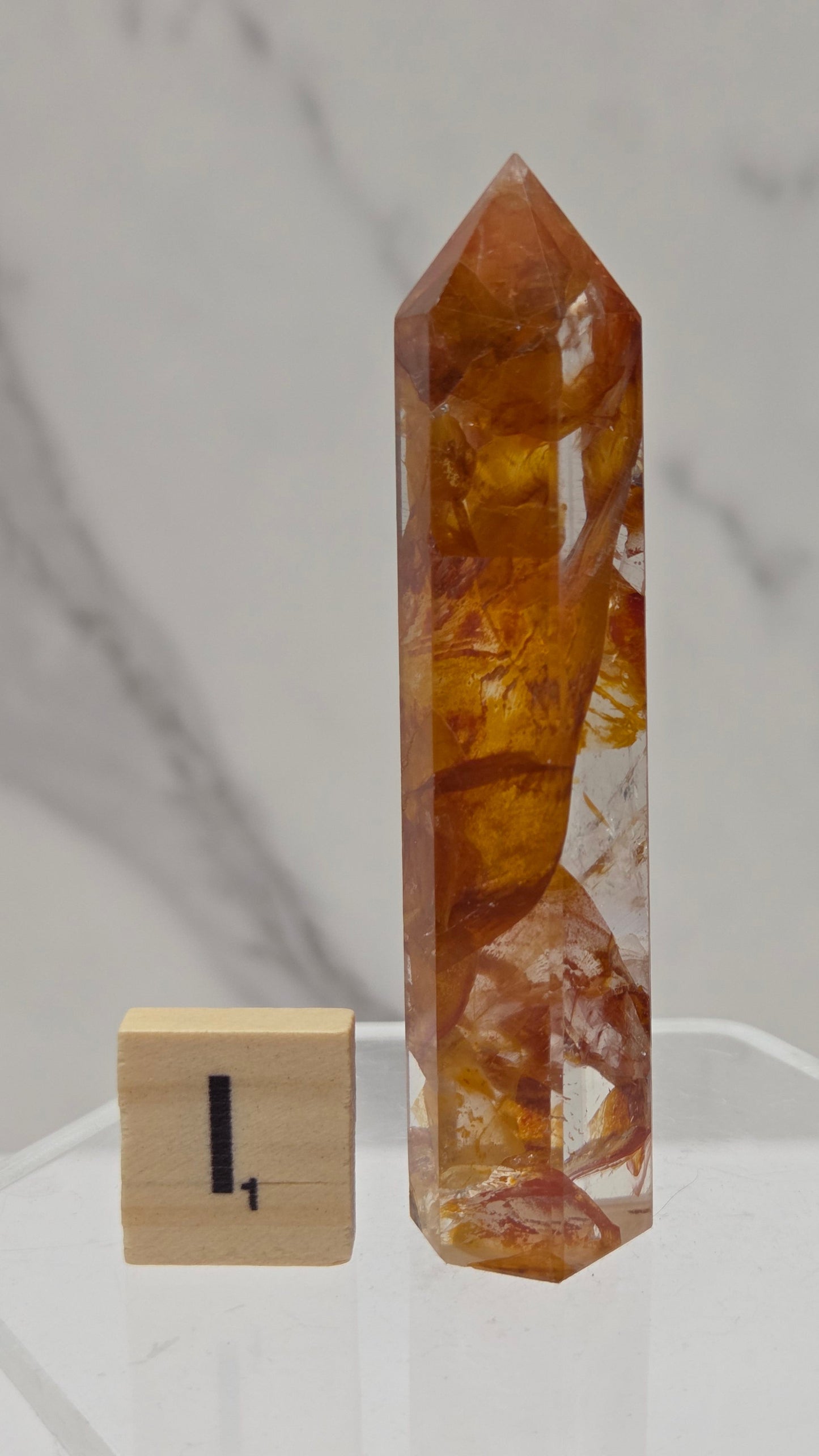 Golden Healer tower on a clear stand against a white background