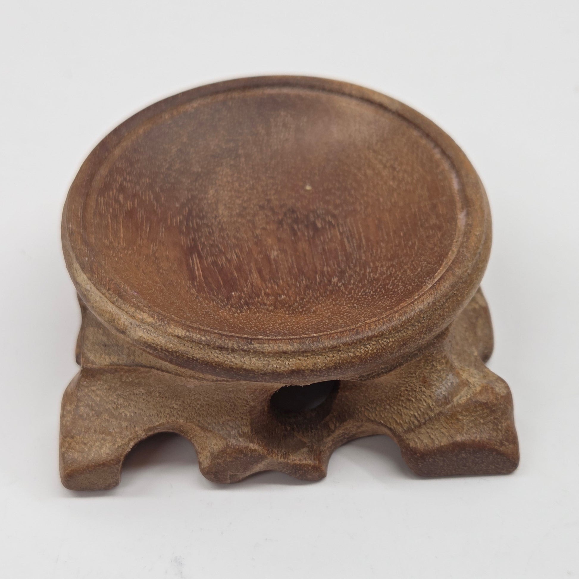 Wooden sphere stands with legs on a white background