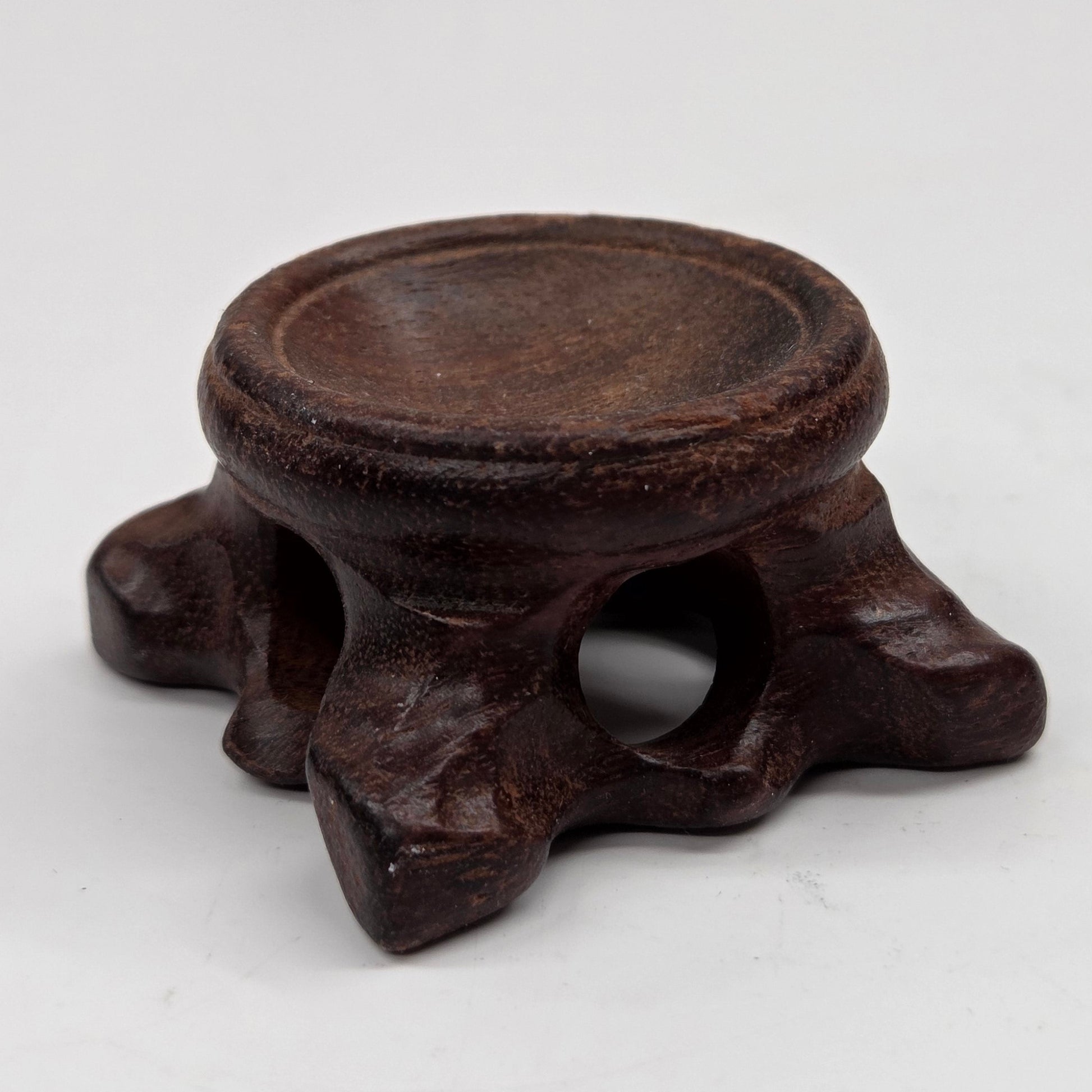 Wooden sphere stands with legs on a white background