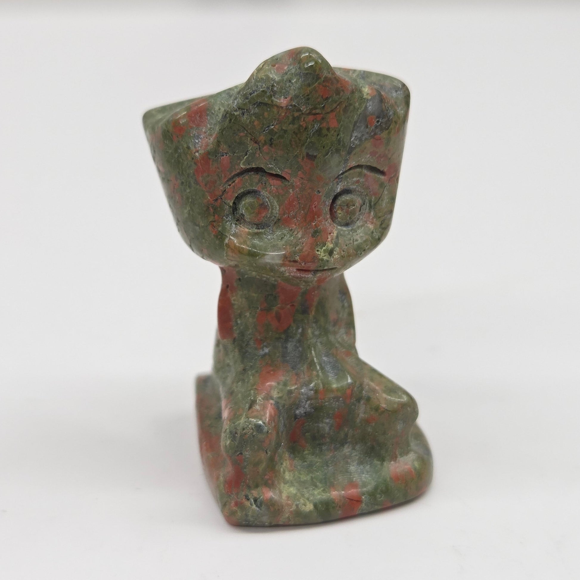Unakite sculpture of Groot on a white background
