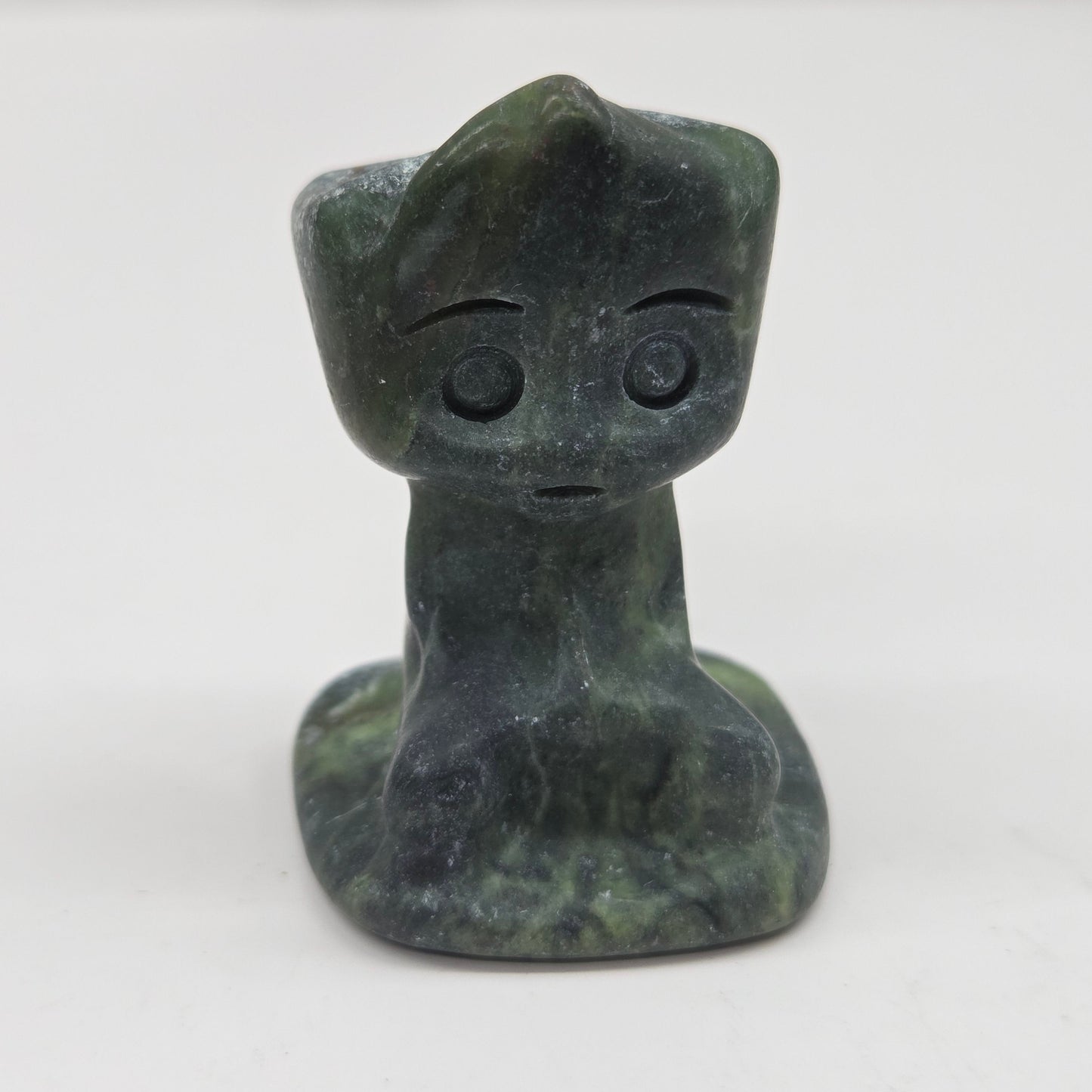 Green Jade sculpture of Groot on a white background