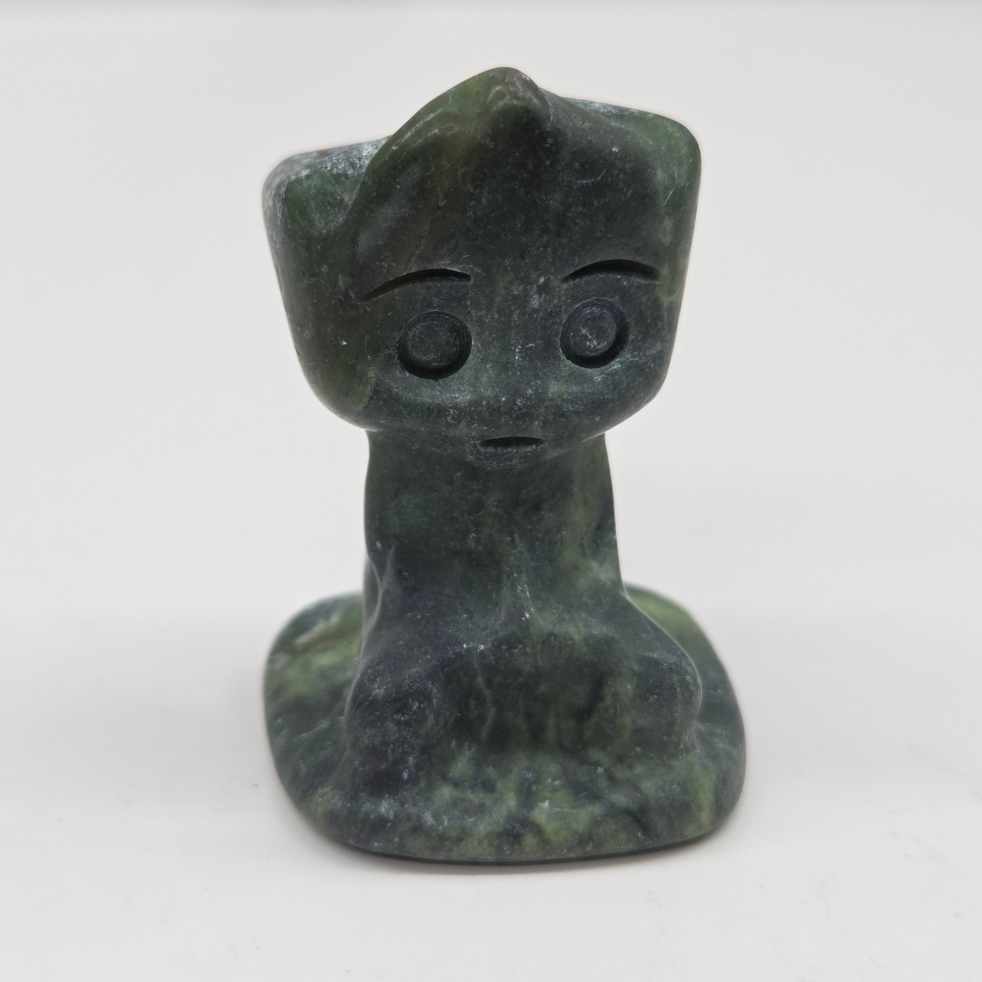 Green Jade sculpture of Groot on a white background