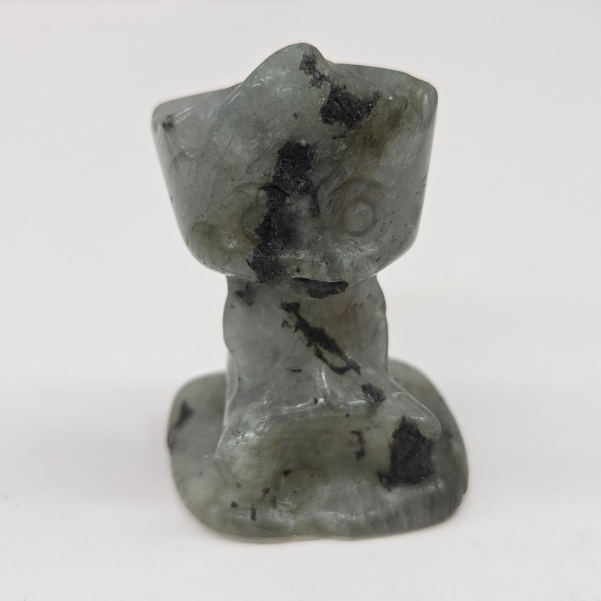 Labradorite sculpture of Groot on a white background