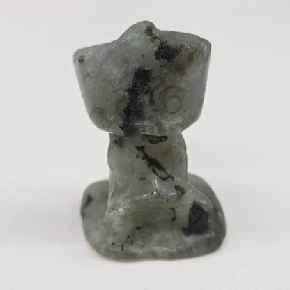 Labradorite sculpture of Groot on a white background
