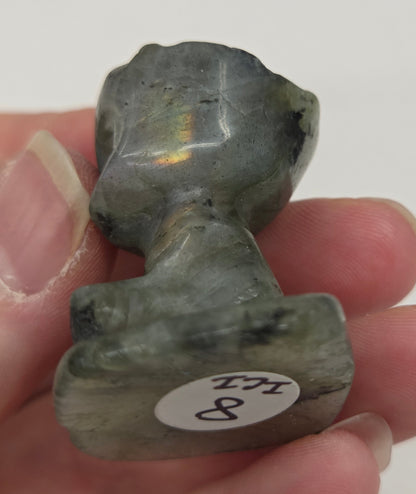 Labradorite sculpture of Groot on a white background