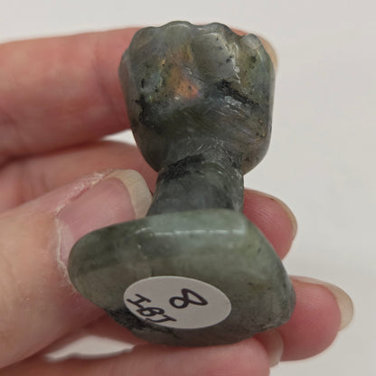 Labradorite sculpture of Groot on a white background