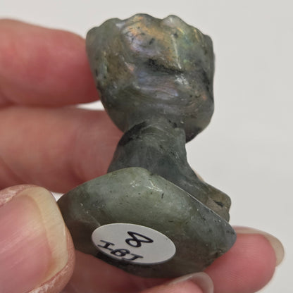 Labradorite sculpture of Groot on a white background