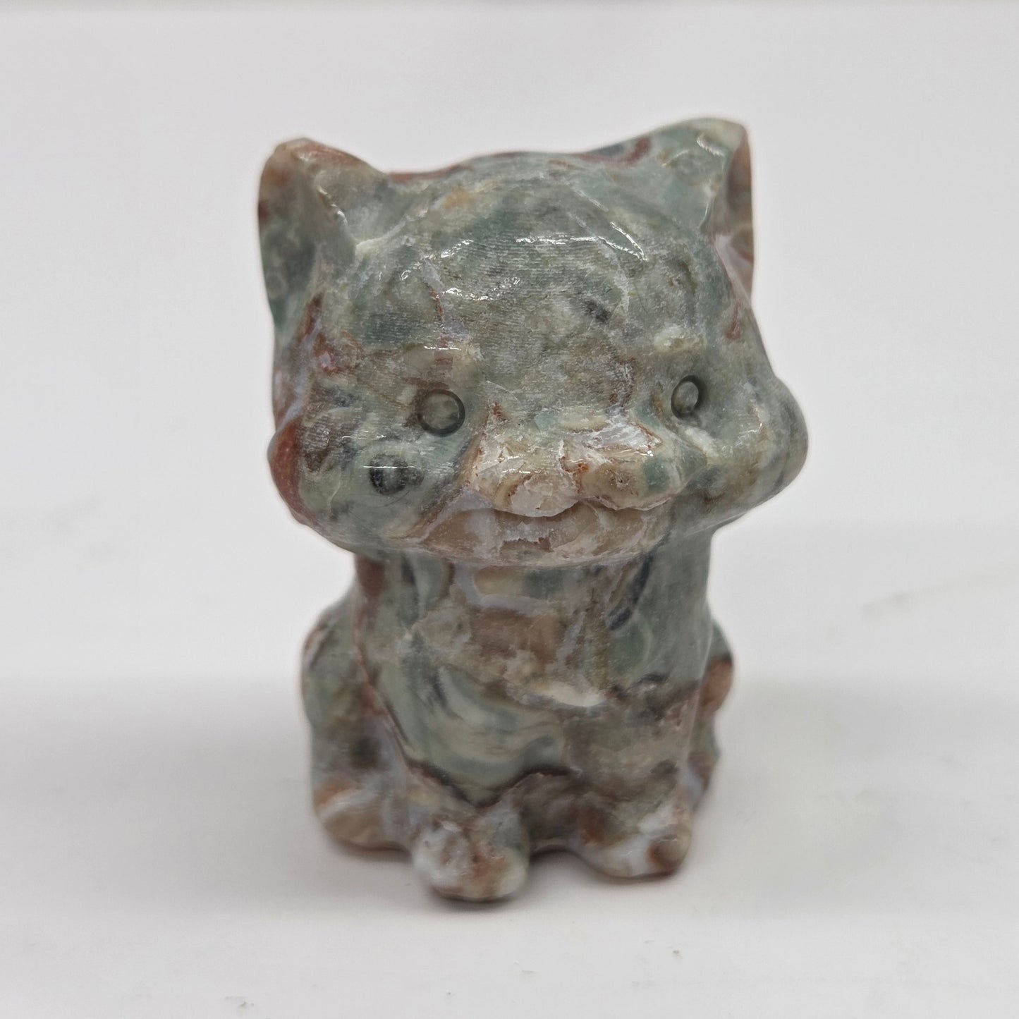 Small Money Agate cat figurine on a white background