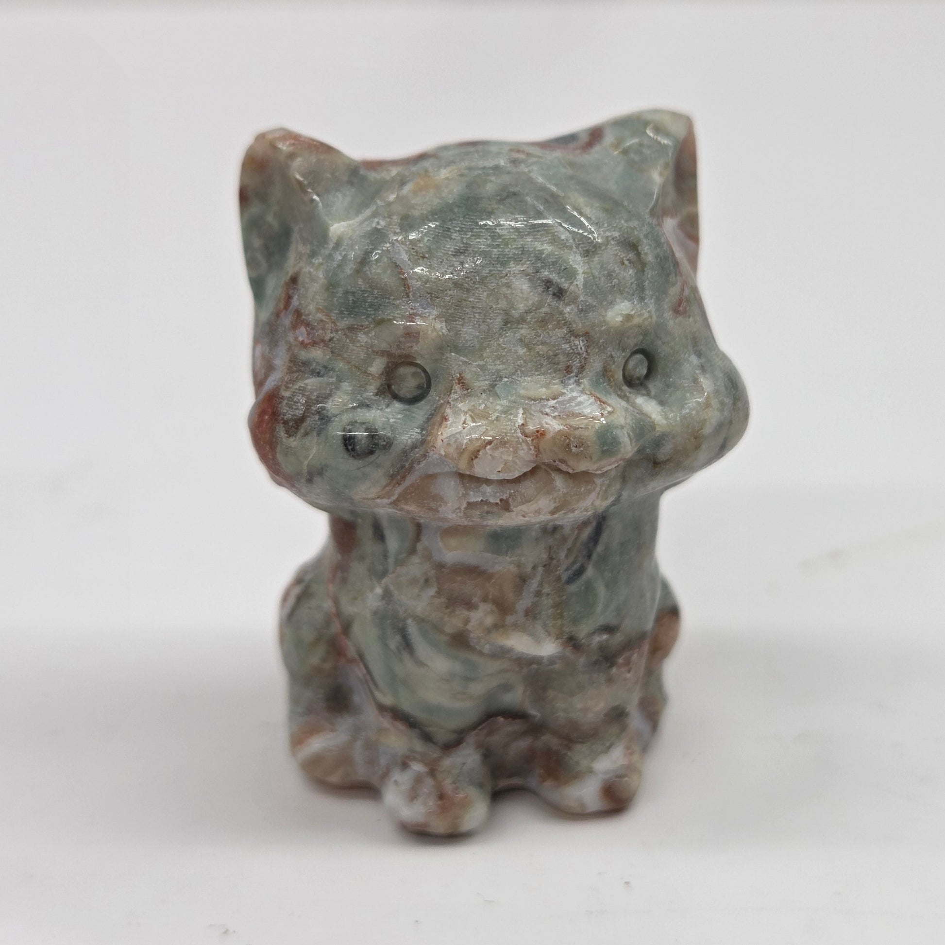 Small Money Agate cat figurine on a white background