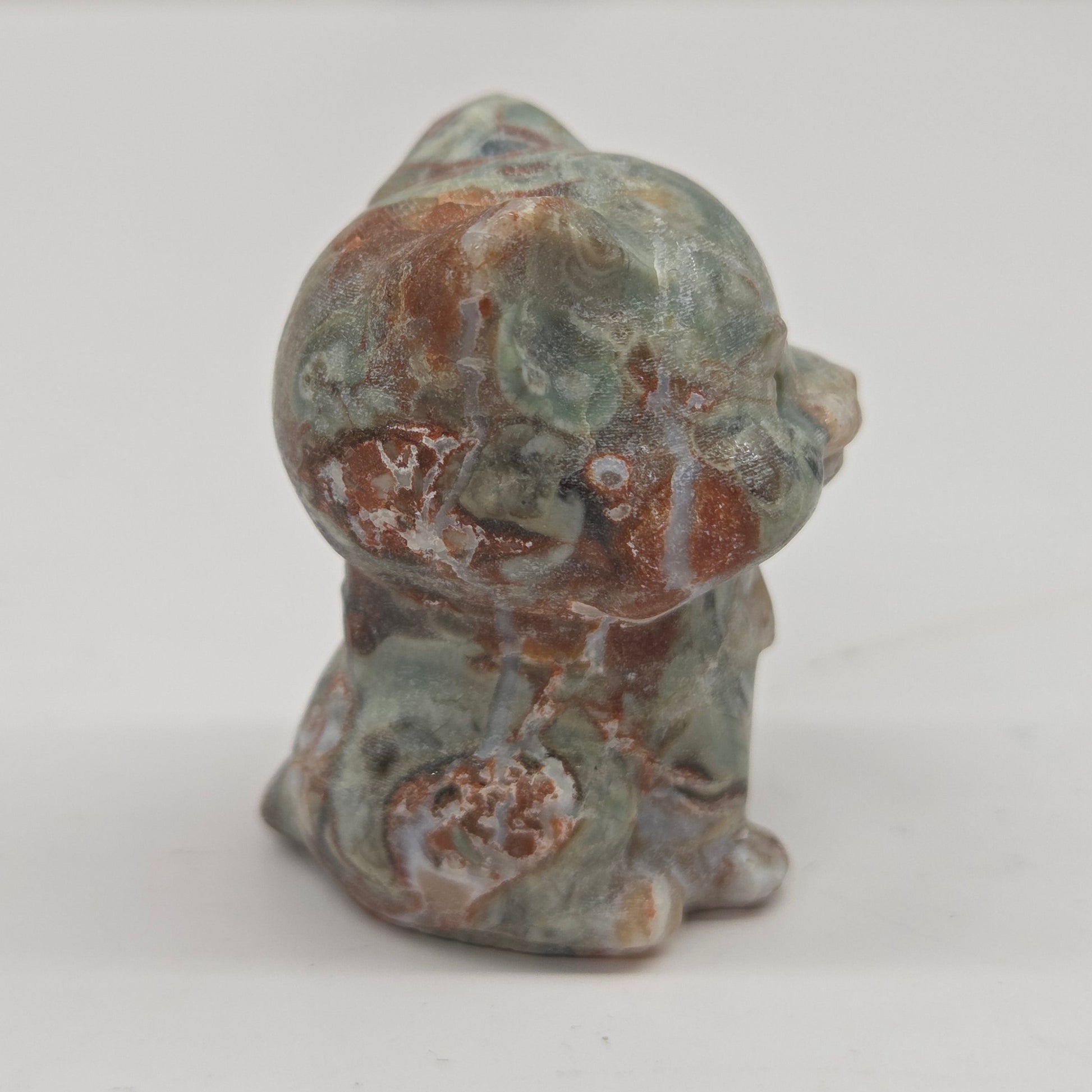 Small Money Agate cat figurine on a white background