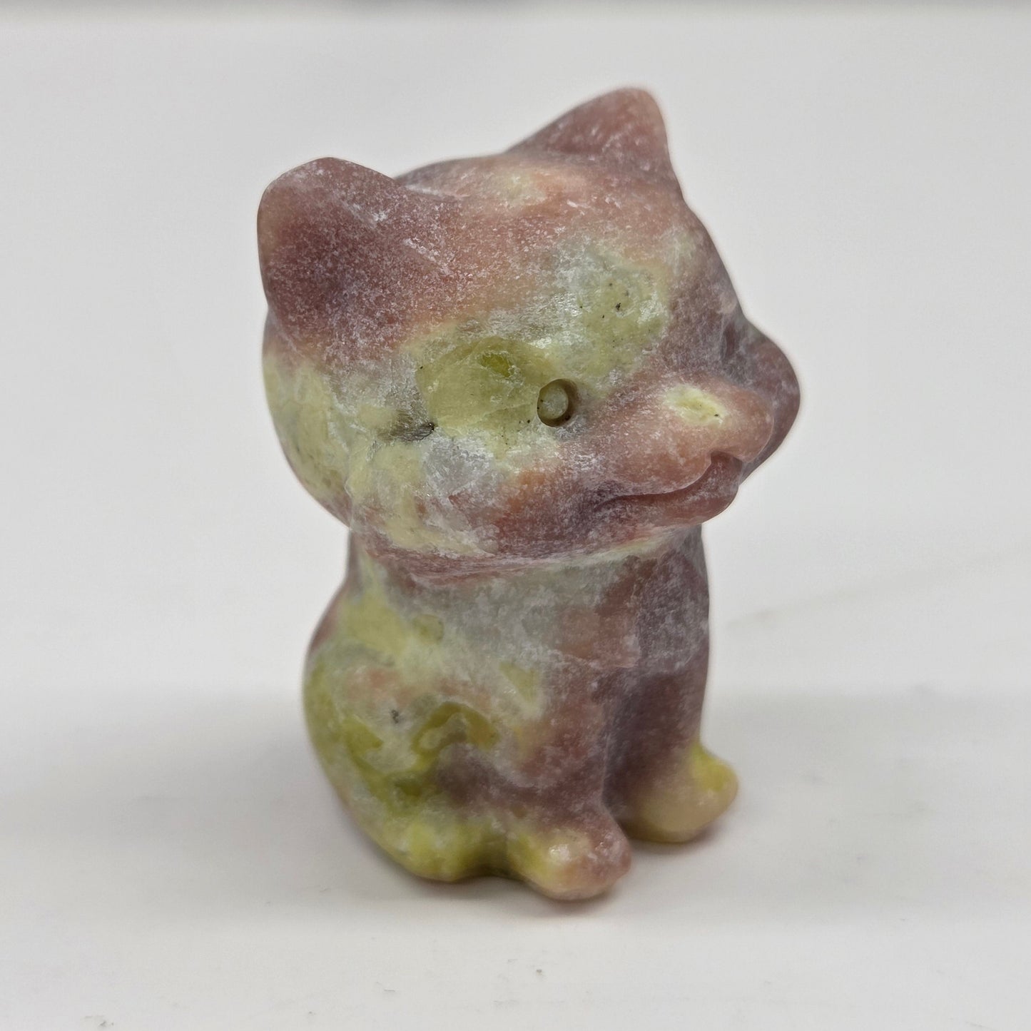 Small Red Serptentine cat figurine on a white background