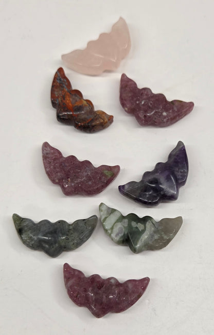 Set of multicolored stone heart with wing carvings on a white background