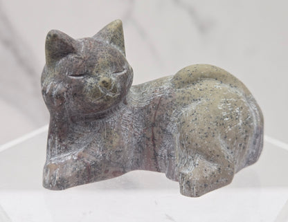 Picture Jasper cat carving lying down an acrylic stand against a neutral background
