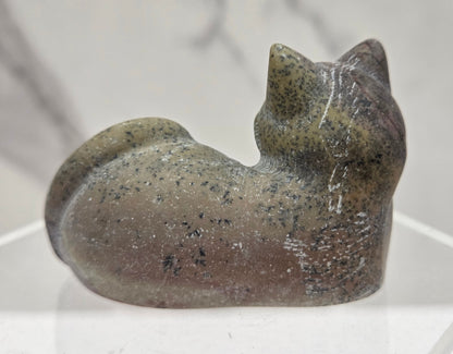 Picture Jasper cat carving lying down an acrylic stand against a neutral background