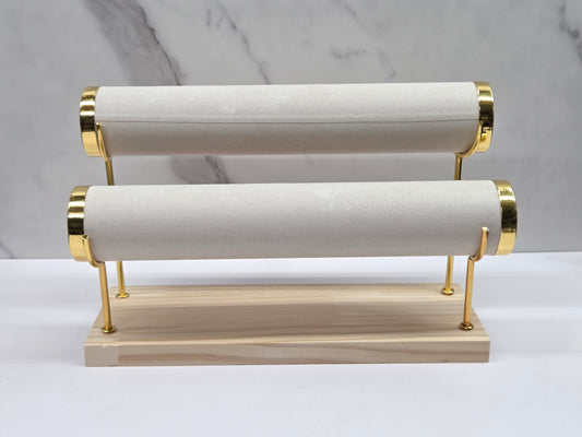 Two-tiered bracelet holder with gold accents on a marble background