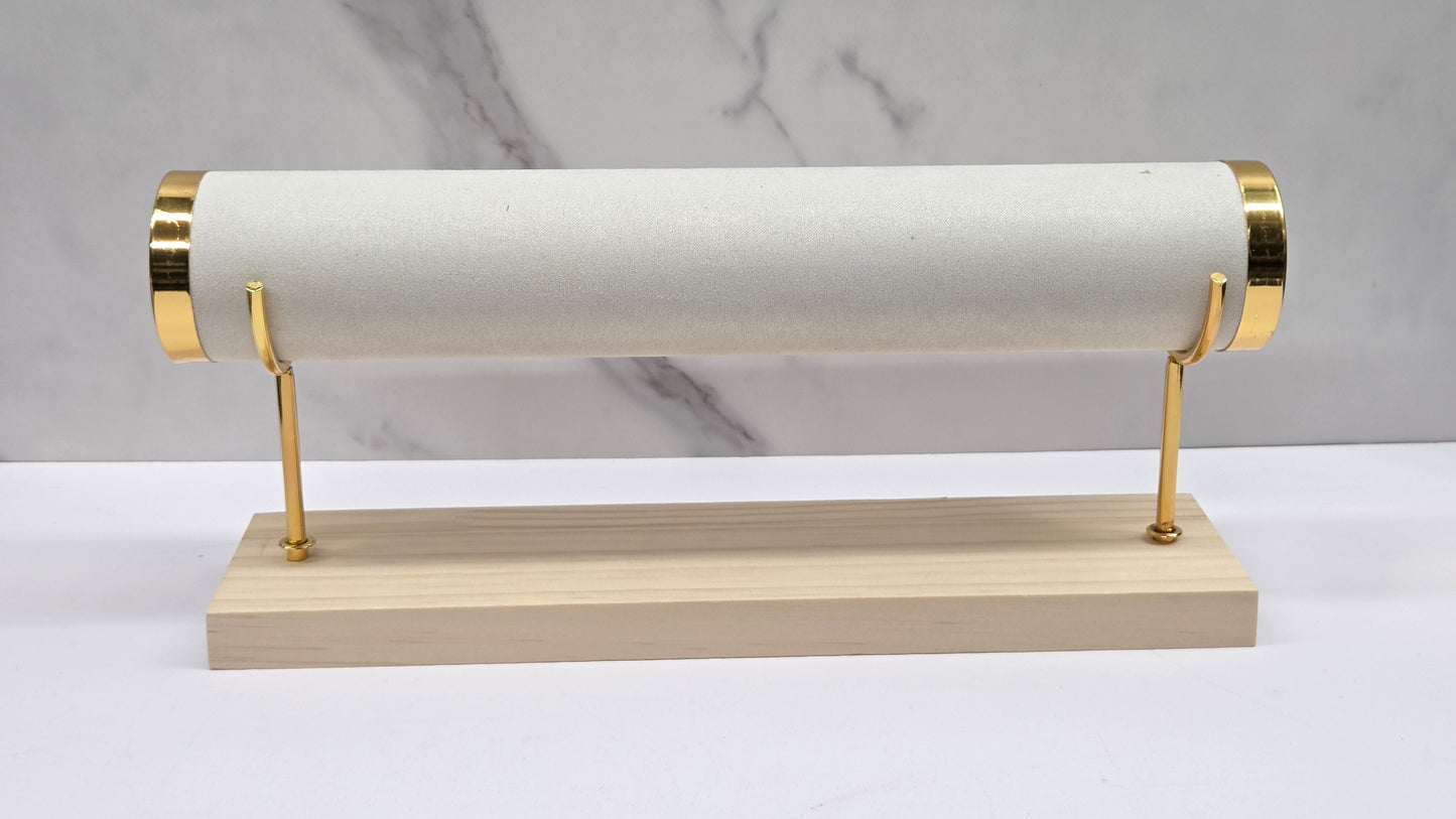 Single-tiered bracelet holder with gold accents on a marble background