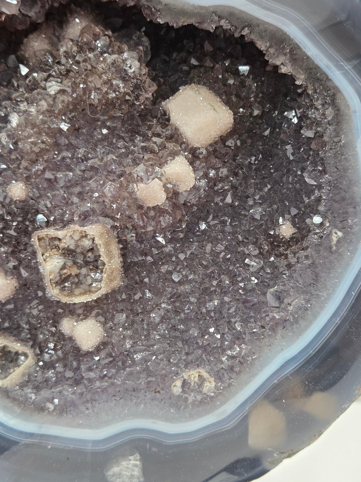 Close-up of an Amethyst and Agate round geode with white calcite inclusions