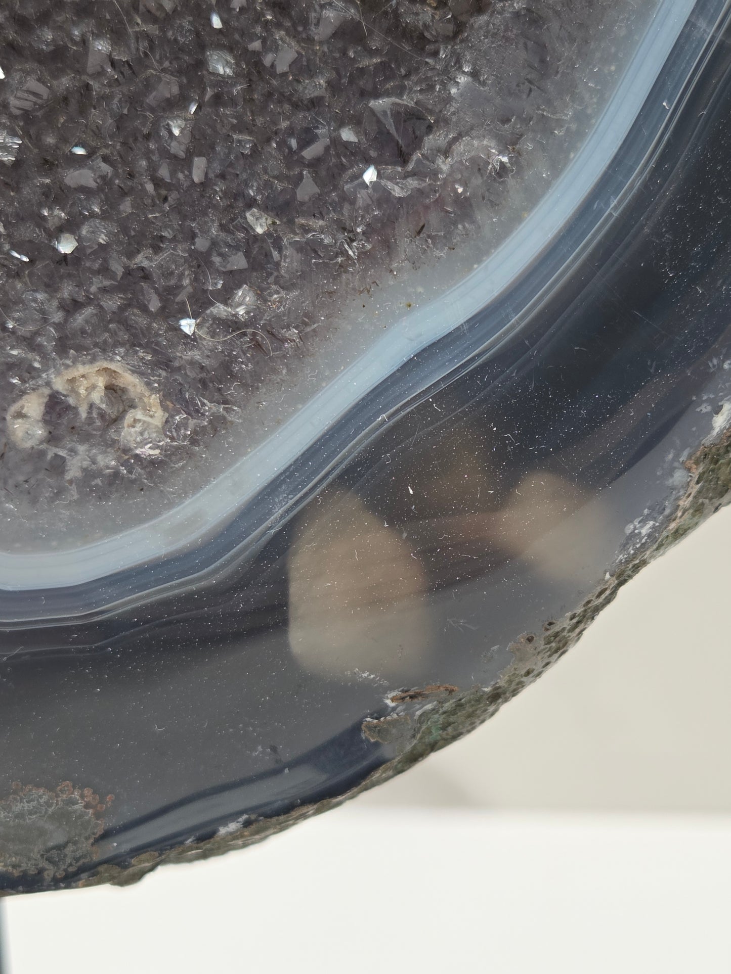 Close-up of an Amethyst and Agate round geode with white calcite inclusions
