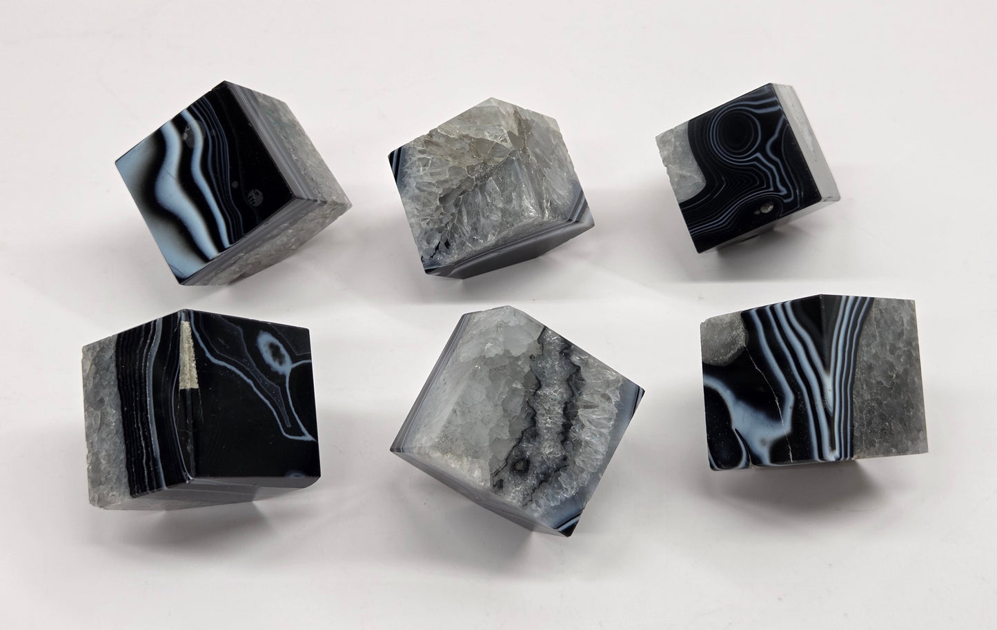 Black Agate cube shapes with black and white banding and quartz on a white background
